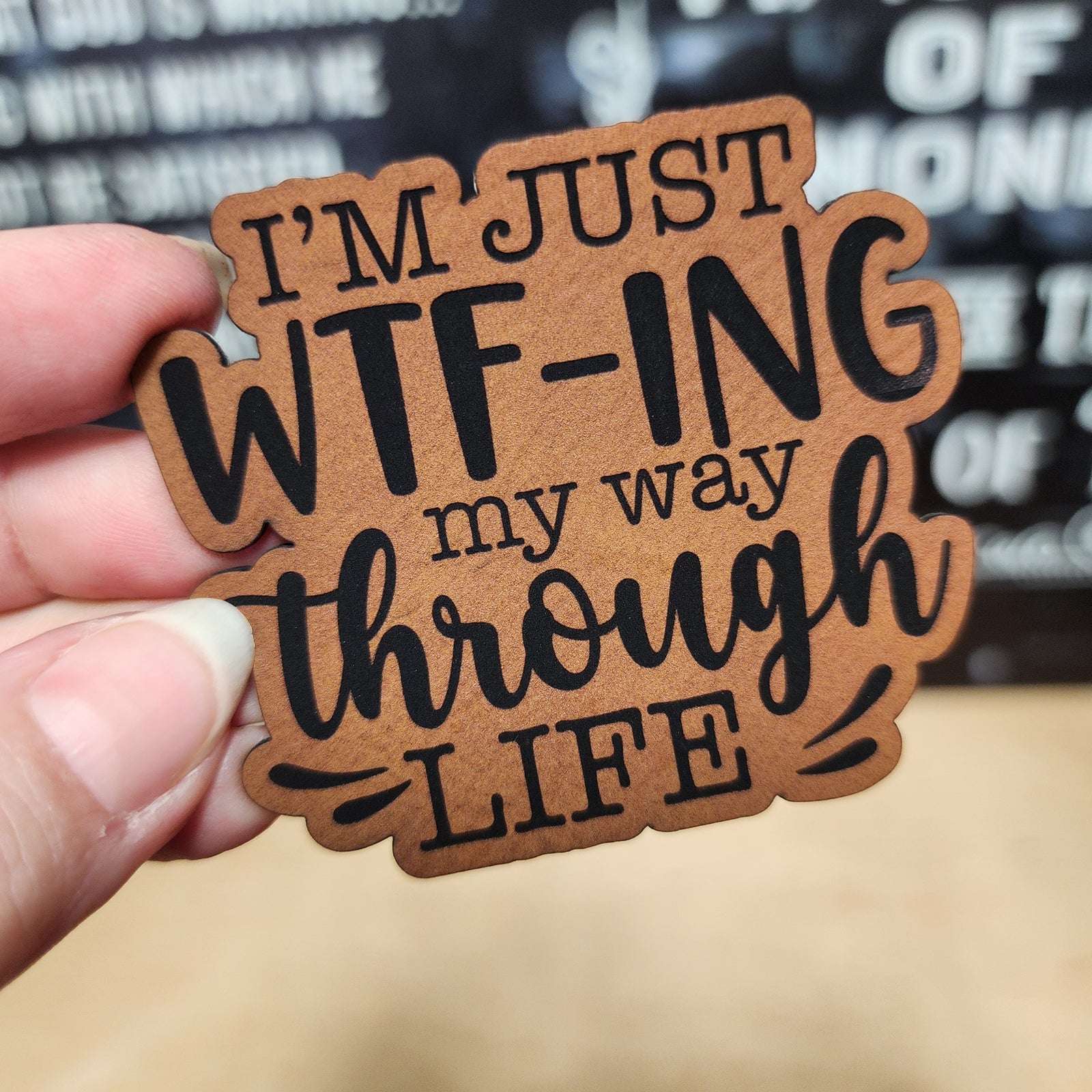 Leatherette hat patch with humorous quote 'I’m just WTF-ING my way through life' for quirky accessories.