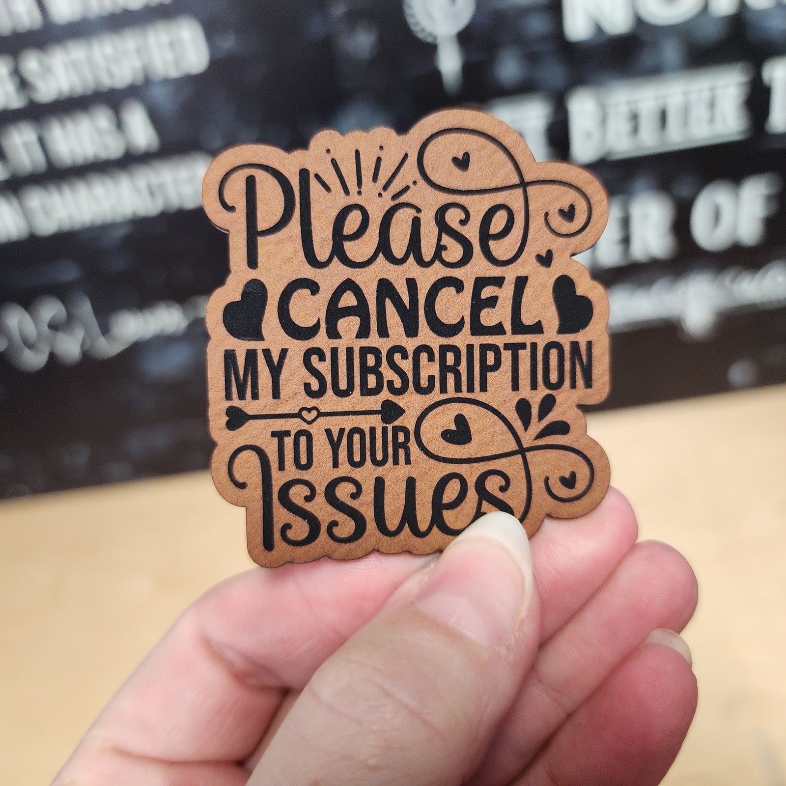 Funny leatherette hat patch that says 'Please Cancel My Subscription to Your Issues' for quirky hat lovers.