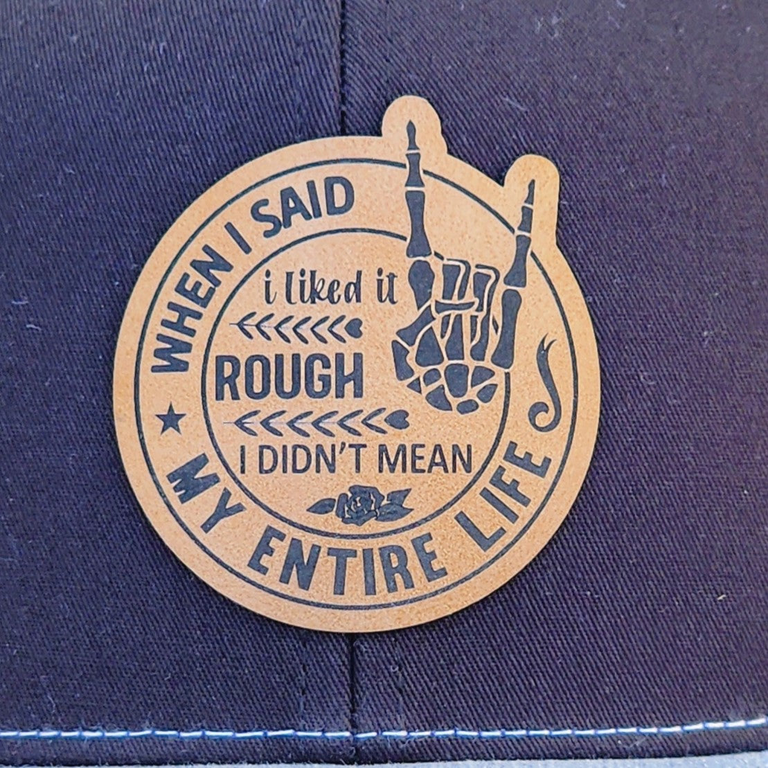 Leatherette hat patch with humorous quote: "When I said I liked it rough, I didn't mean my entire life."