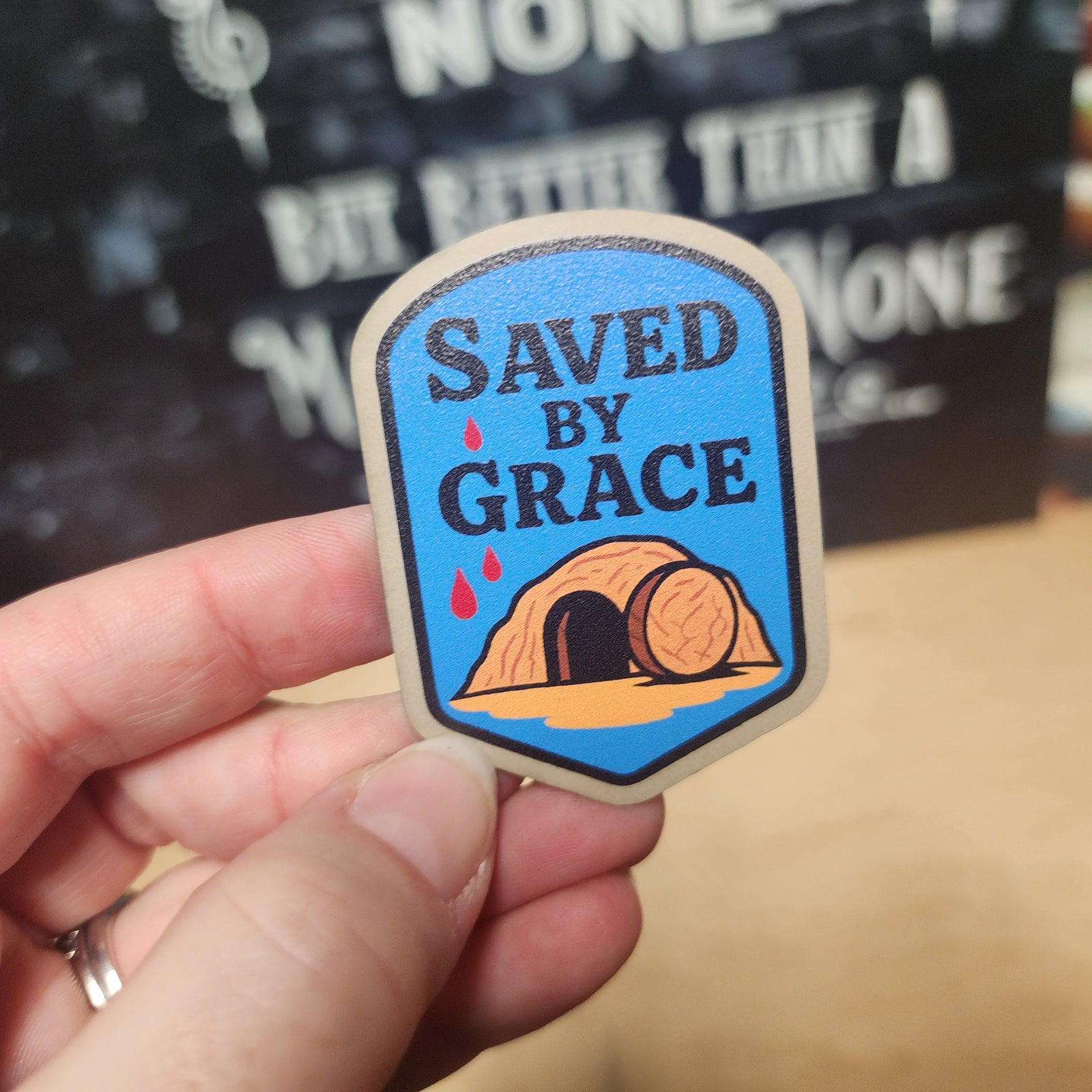 Saved by Grace leatherette hat patch featuring a cave and barrel design, perfect for faith-based accessories.