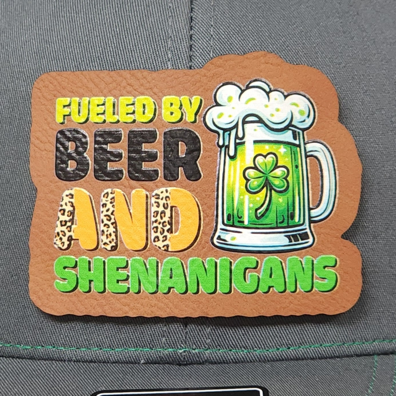 St. Patrick's Day leatherette hat patch with beer mug, clover, and 'Fueled by Beer and Shenanigans' text.