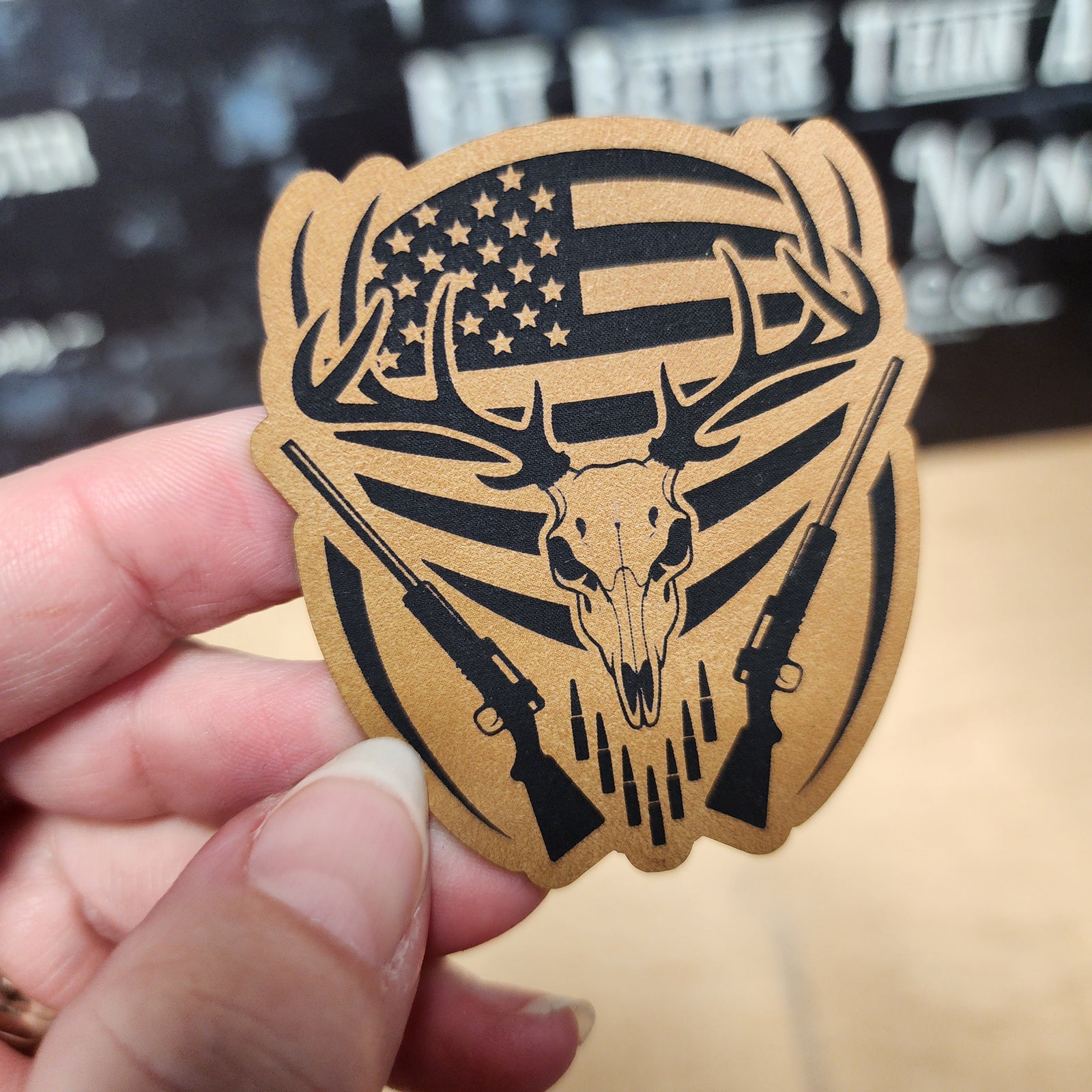 Hunting skull leatherette hat patch with American flag and rifles, perfect for outdoor enthusiasts.