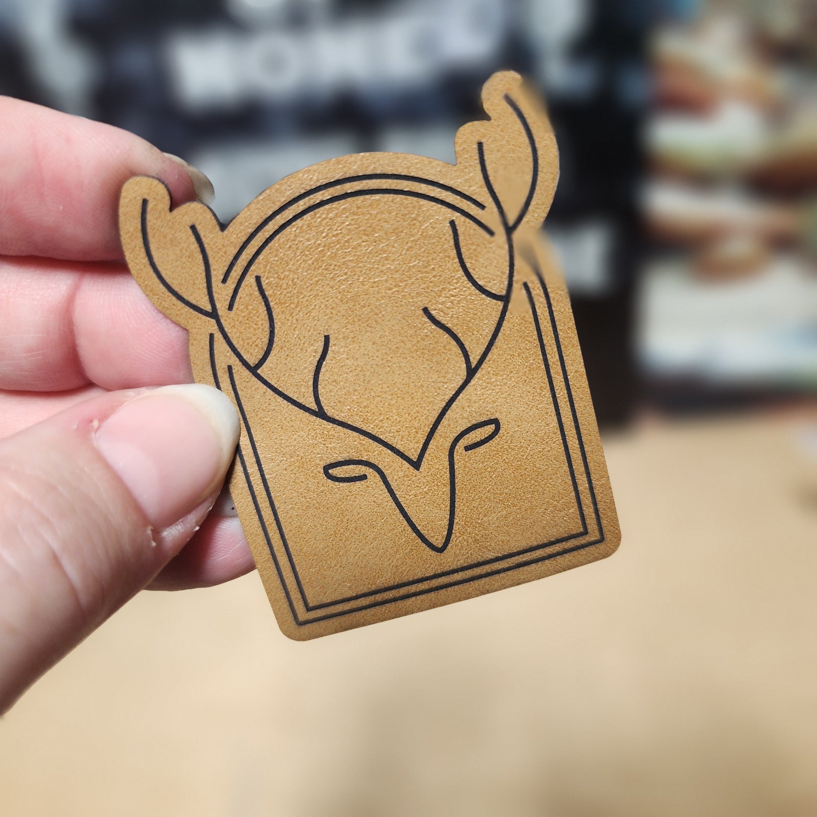 Stylish leatherette deer head hat patch for outdoor enthusiasts and hunting apparel.