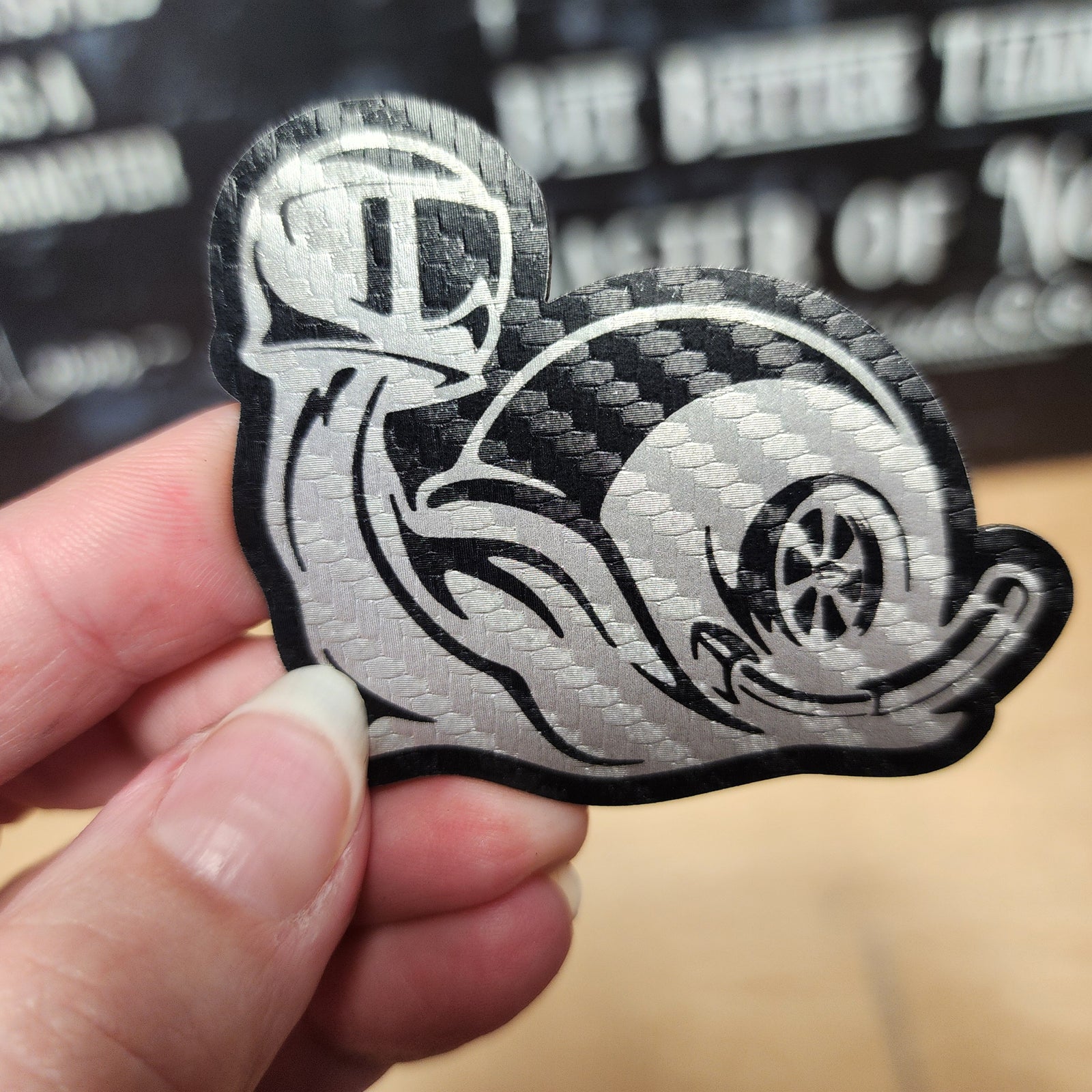 Racing snail leatherette patch featuring a sporty design, perfect for automotive enthusiasts or casual wear.