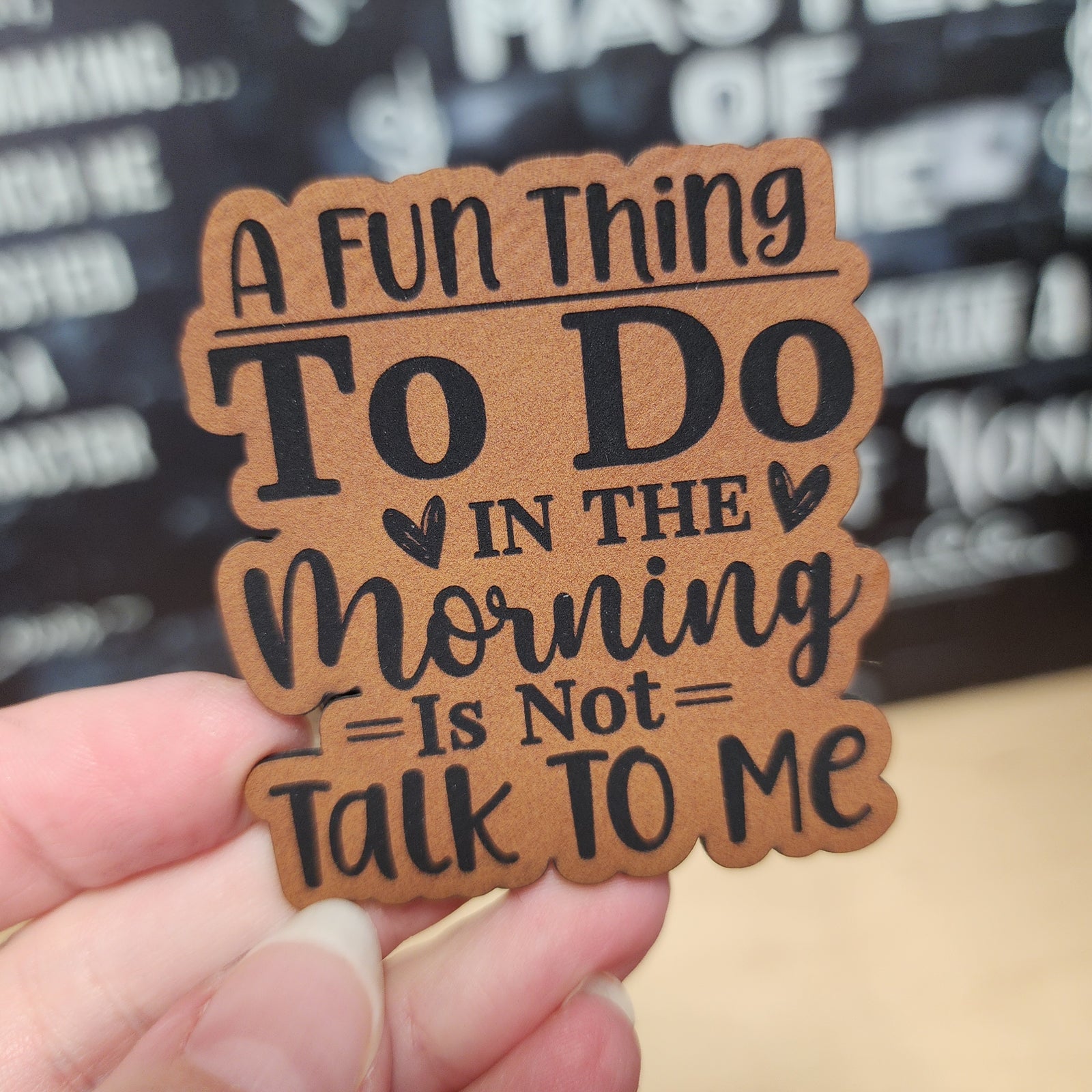 Funny leatherette hat patch that reads 'A Fun Thing To Do In The Morning Is Not Talk To Me' for quirky gifts.