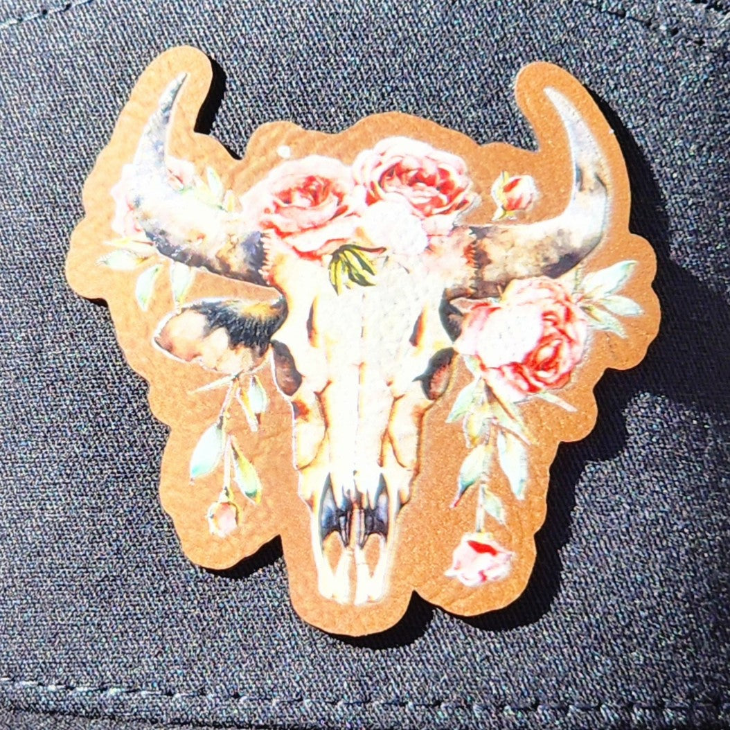 Cow skull leatherette hat patch with floral accents, perfect for western-themed accessories and gifts.