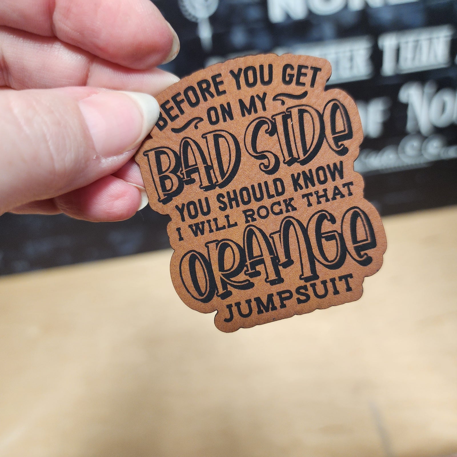 Funny leatherette hat patch, sarcastic orange jumpsuit message, perfect for retro fashion enthusiasts and gifts.
