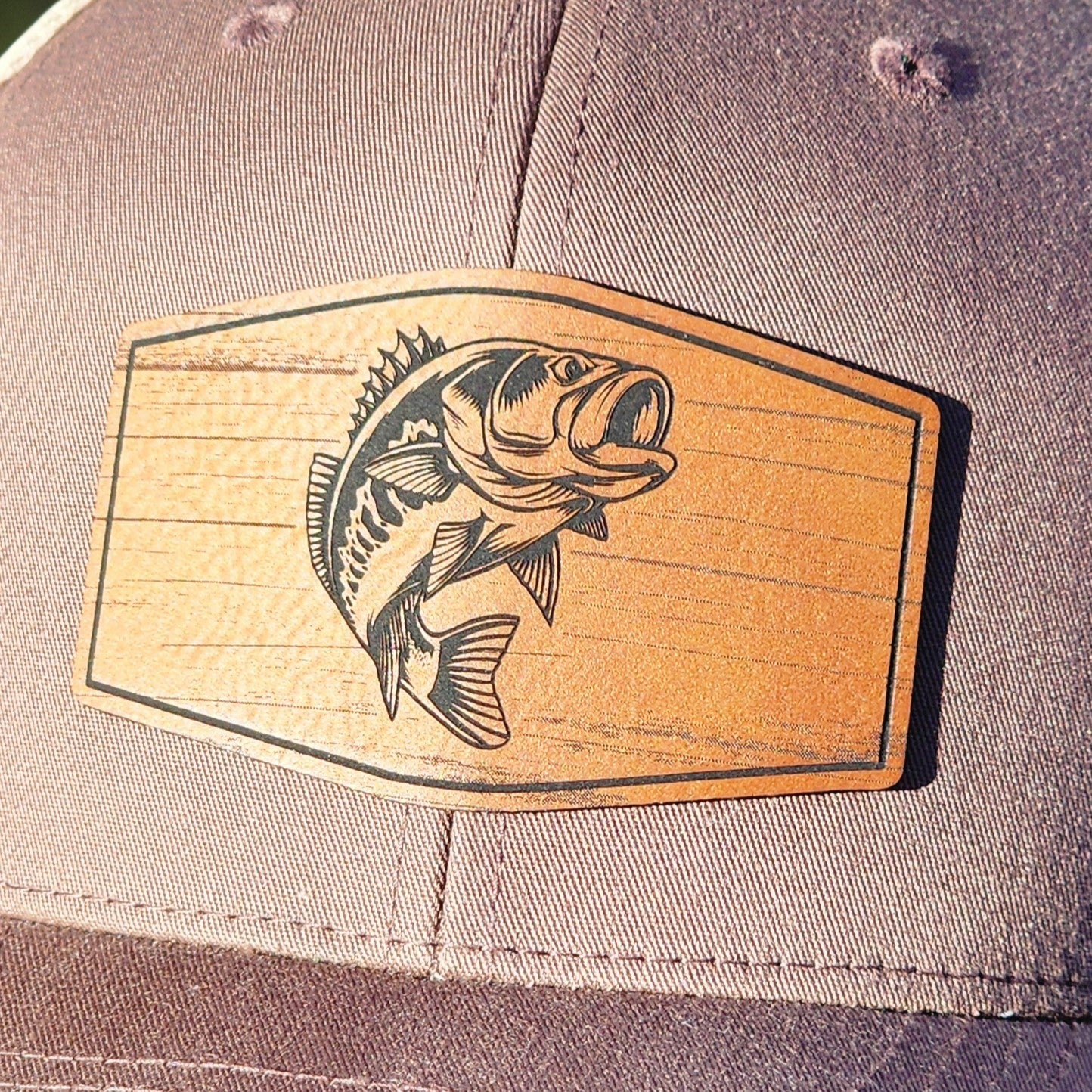 Fishing hat patch featuring a bass fish design on a leatherette background, perfect for outdoor enthusiasts.