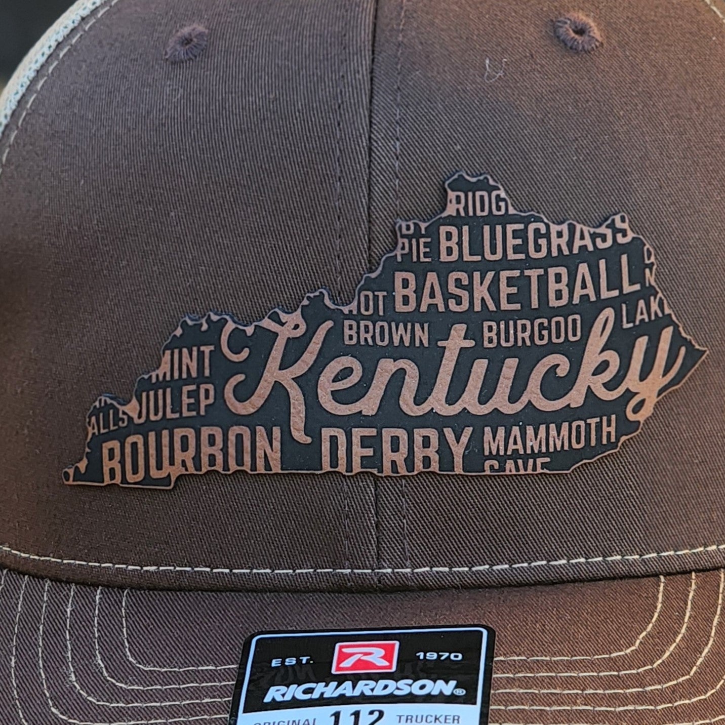Kentucky leatherette hat patch featuring bourbon, derby, and basketball, perfect for any Kentucky fan.