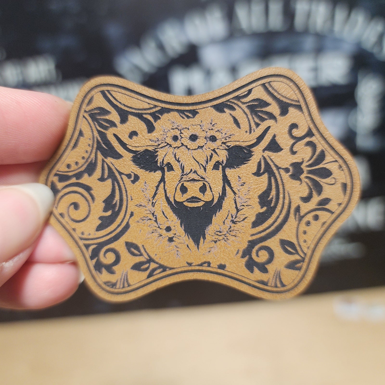 Cow leatherette hat patch with floral design, perfect for rustic and country-themed apparel accessories.