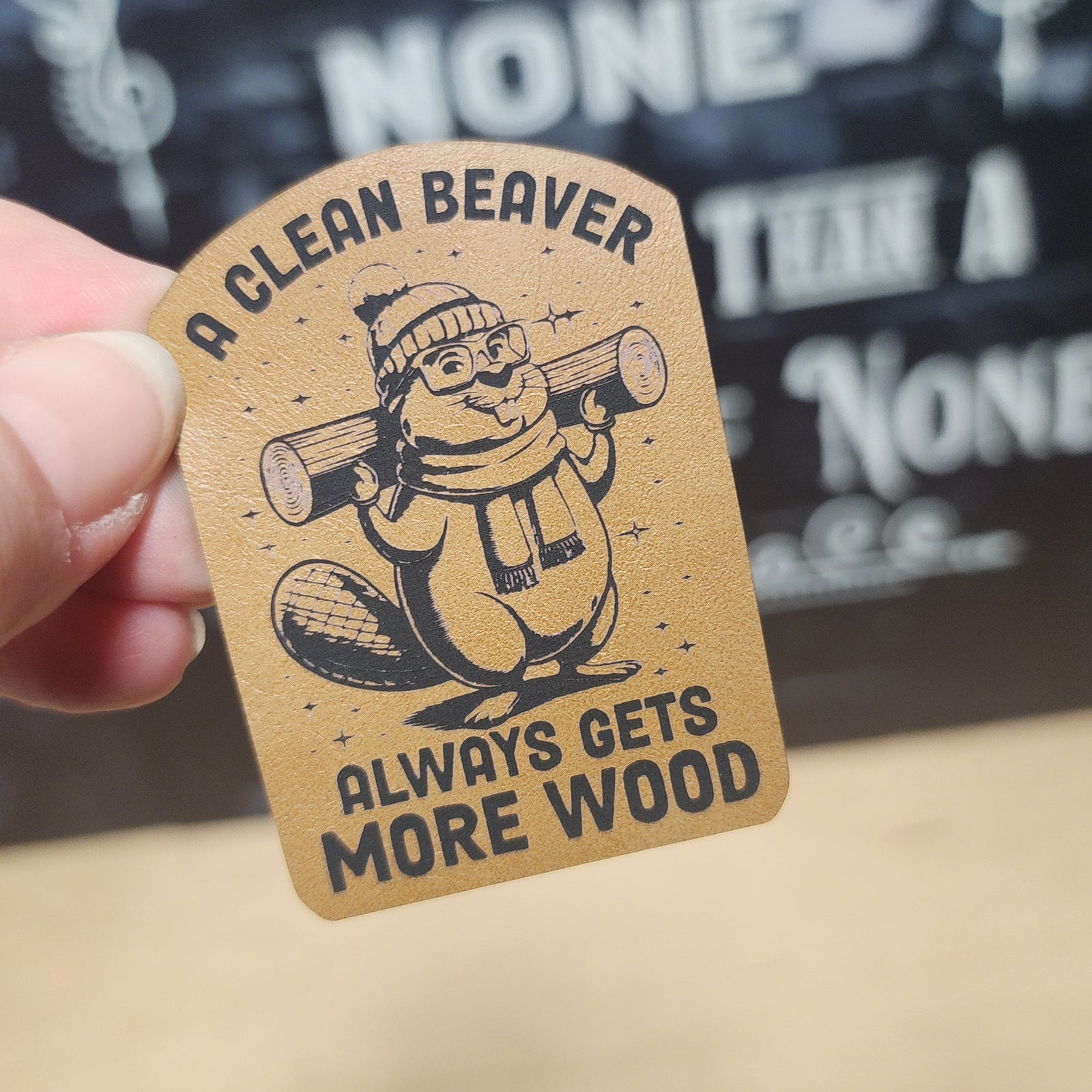 Funny beaver leatherette hat patch with humorous saying, perfect for outdoor enthusiasts and casual wear.
