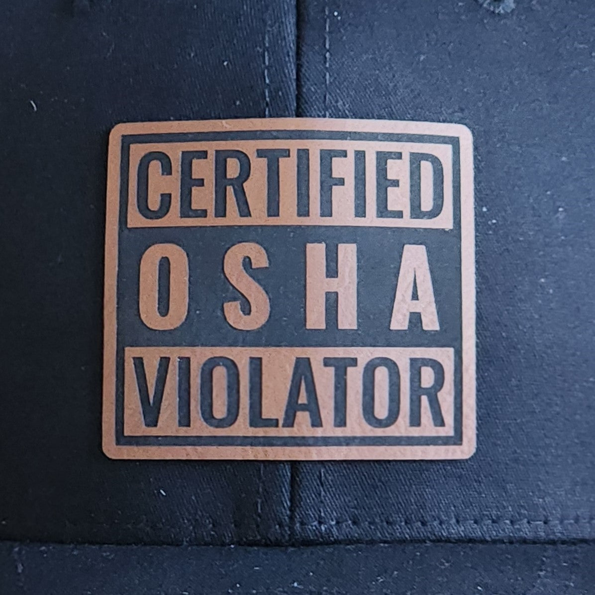 Certified OSHA Violator leatherette hat patch, perfect for safety-themed gifts and humorous work attire.
