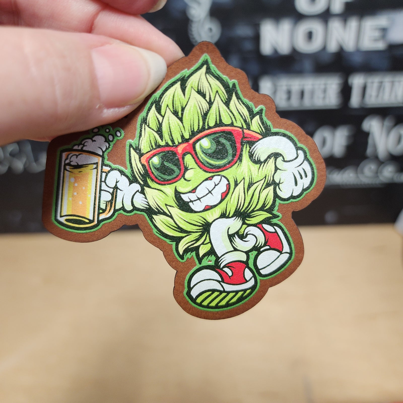 Hop character leatherette hat patch with sunglasses and beer, perfect for craft beer lovers and brewing enthusiasts.