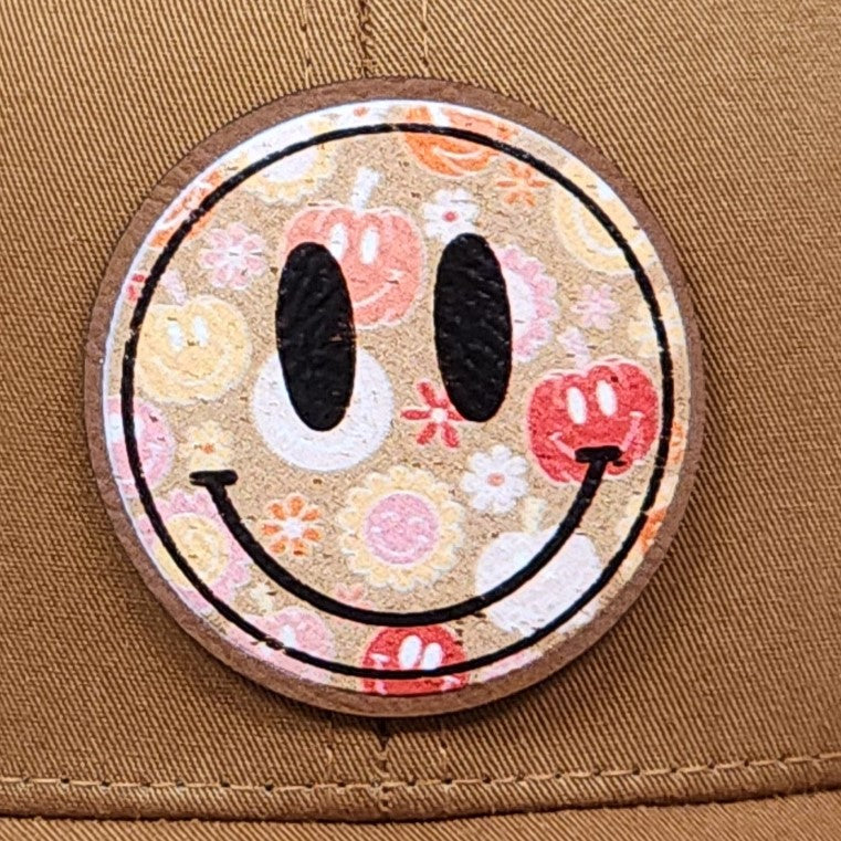 Happy face leatherette hat patch with floral design, perfect for trendy caps and casual summer outfits.