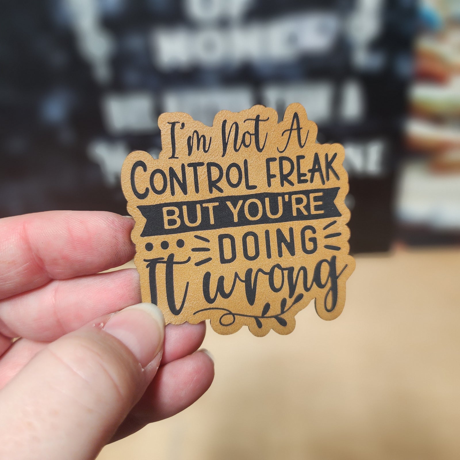Funny leatherette hat patch with witty saying 'I'm not a control freak but you're doing it wrong'.