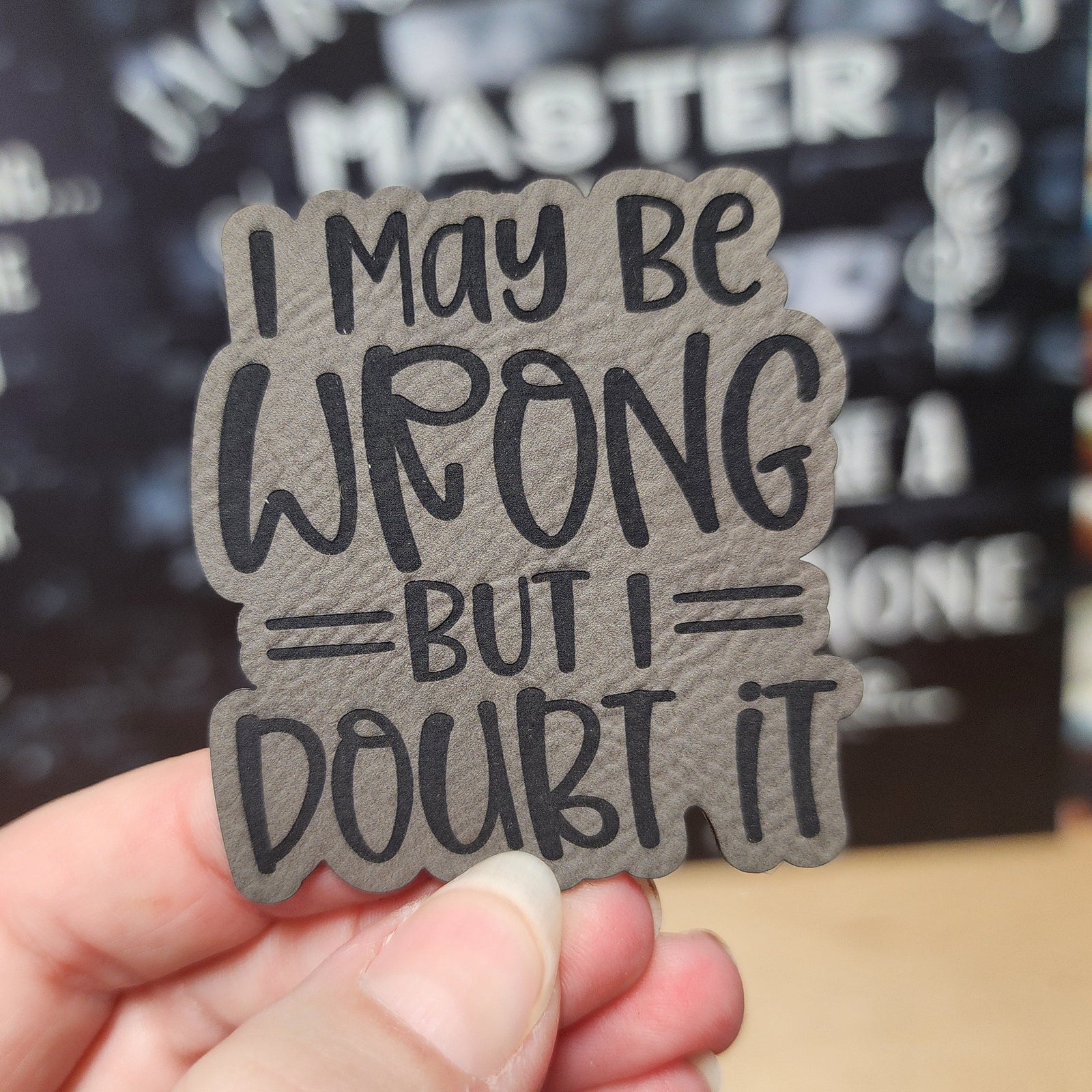Leatherette hat patch with quote 'I may be wrong but I doubt it,' perfect for quirky personality accessories.