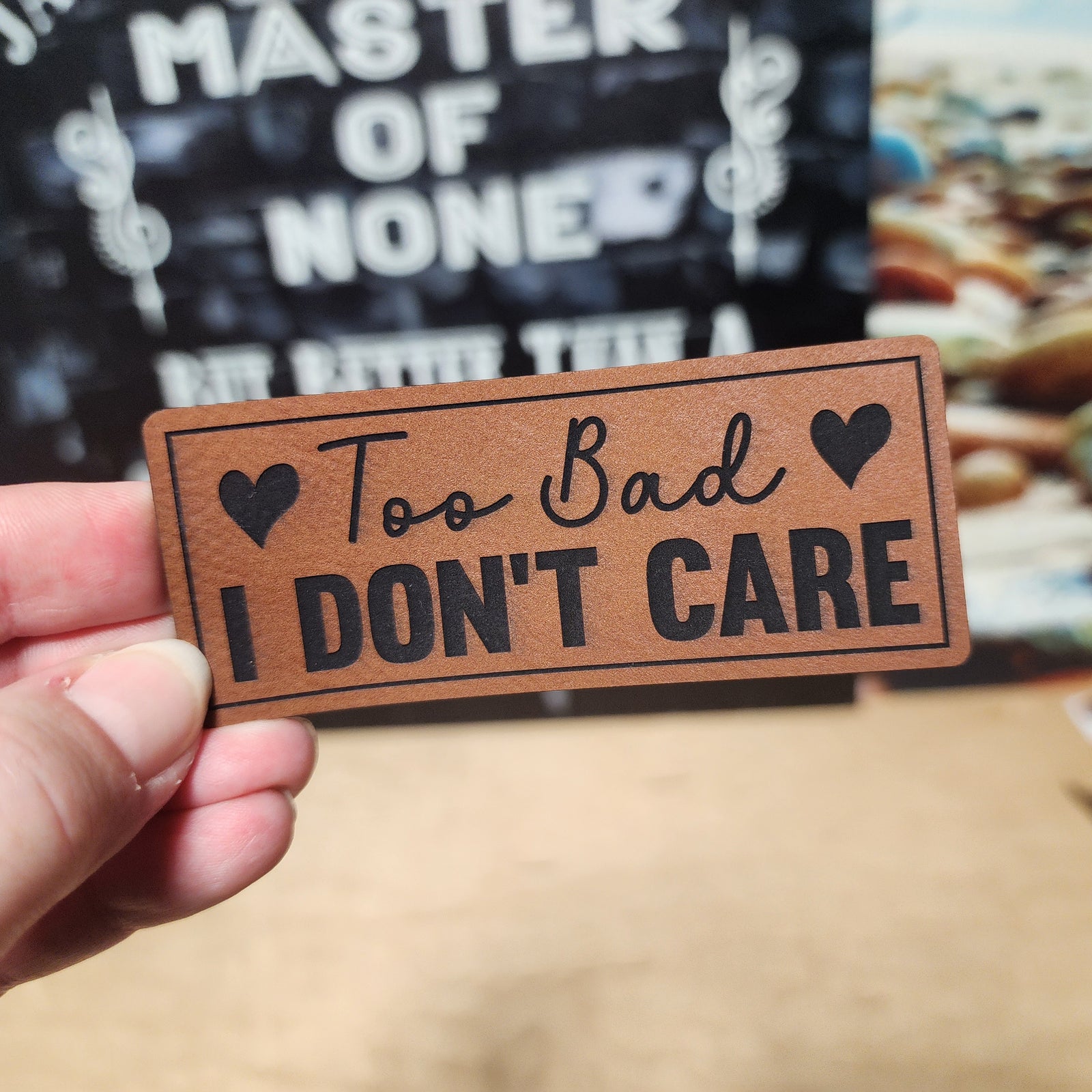 Funny leatherette hat patch, 'Too Bad I Don't Care', perfect for unique hats and humorous accessories.