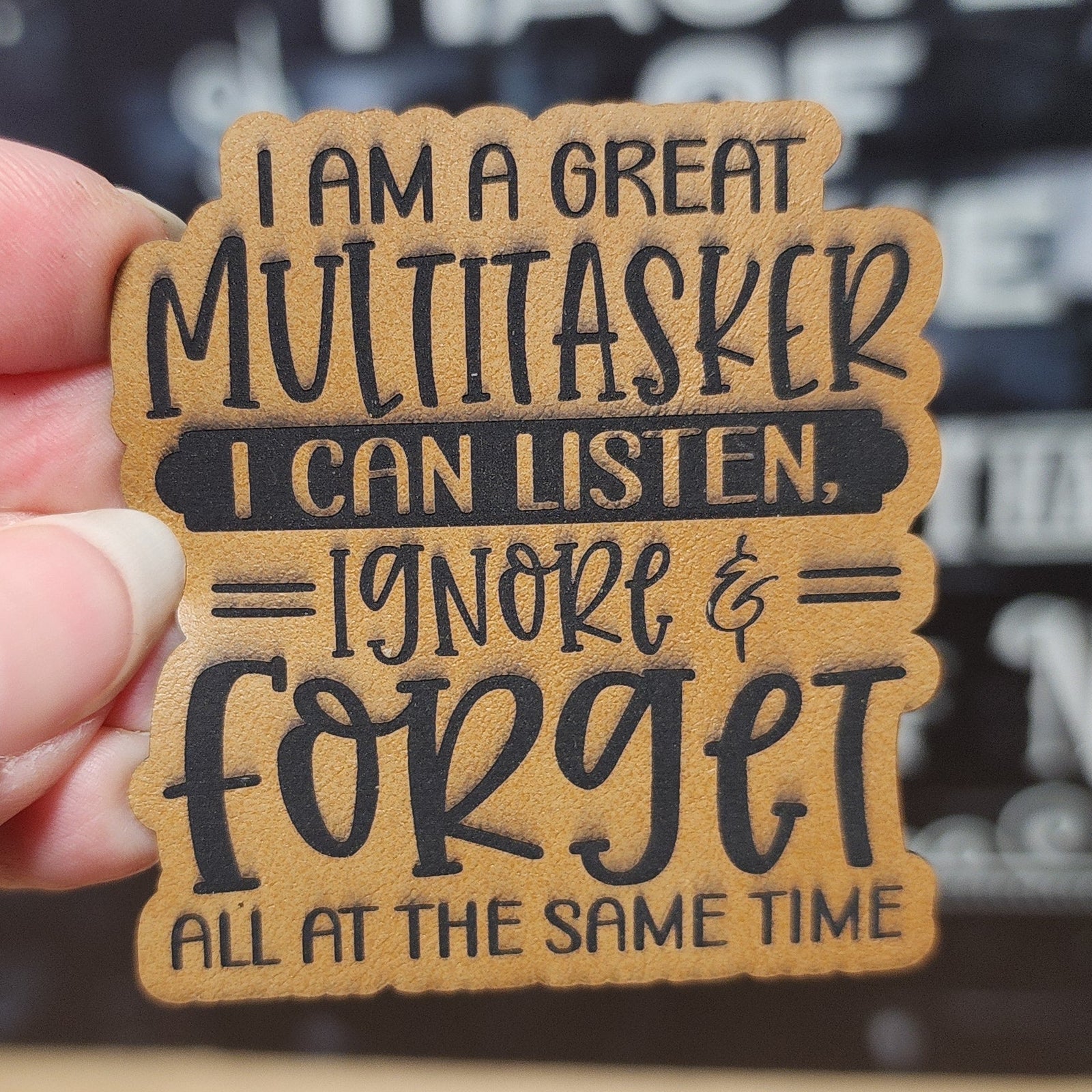 Funny leatherette hat patch saying 'I am a great multitasker, I can listen, ignore & forget all at the same time'.