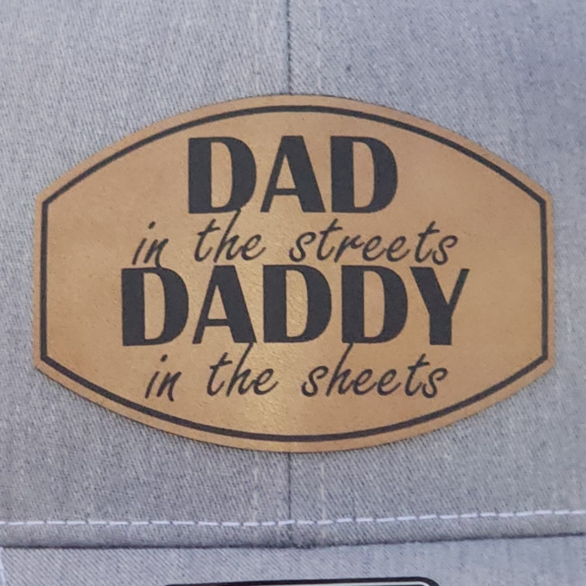 Funny leatherette hat patch featuring 'Dad in the streets, Daddy in the sheets' for stylish dads.