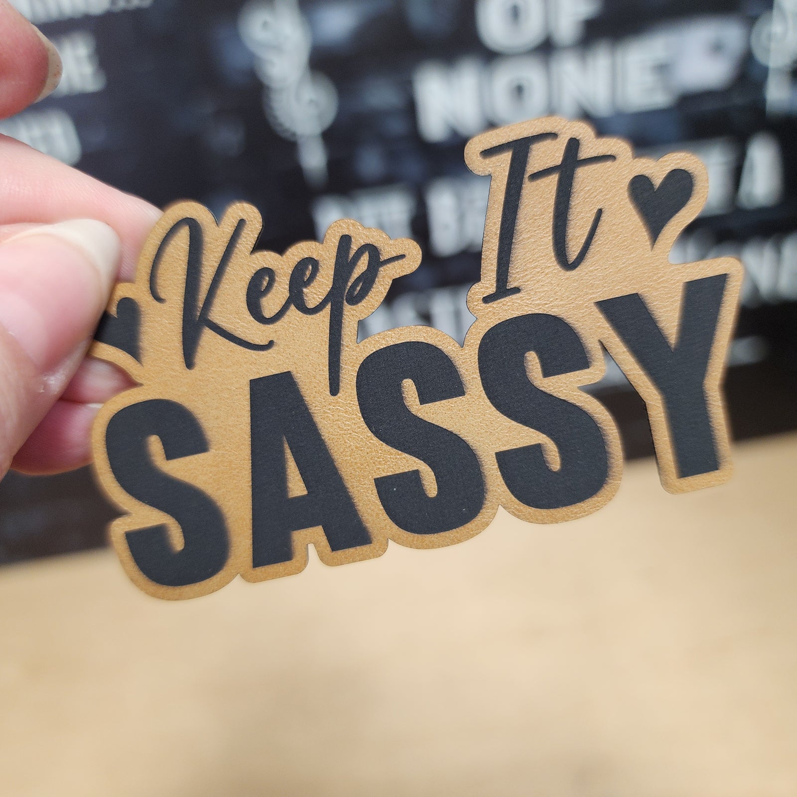 Keep It Sassy leatherette hat patch, perfect for adding a touch of attitude to hats and accessories.