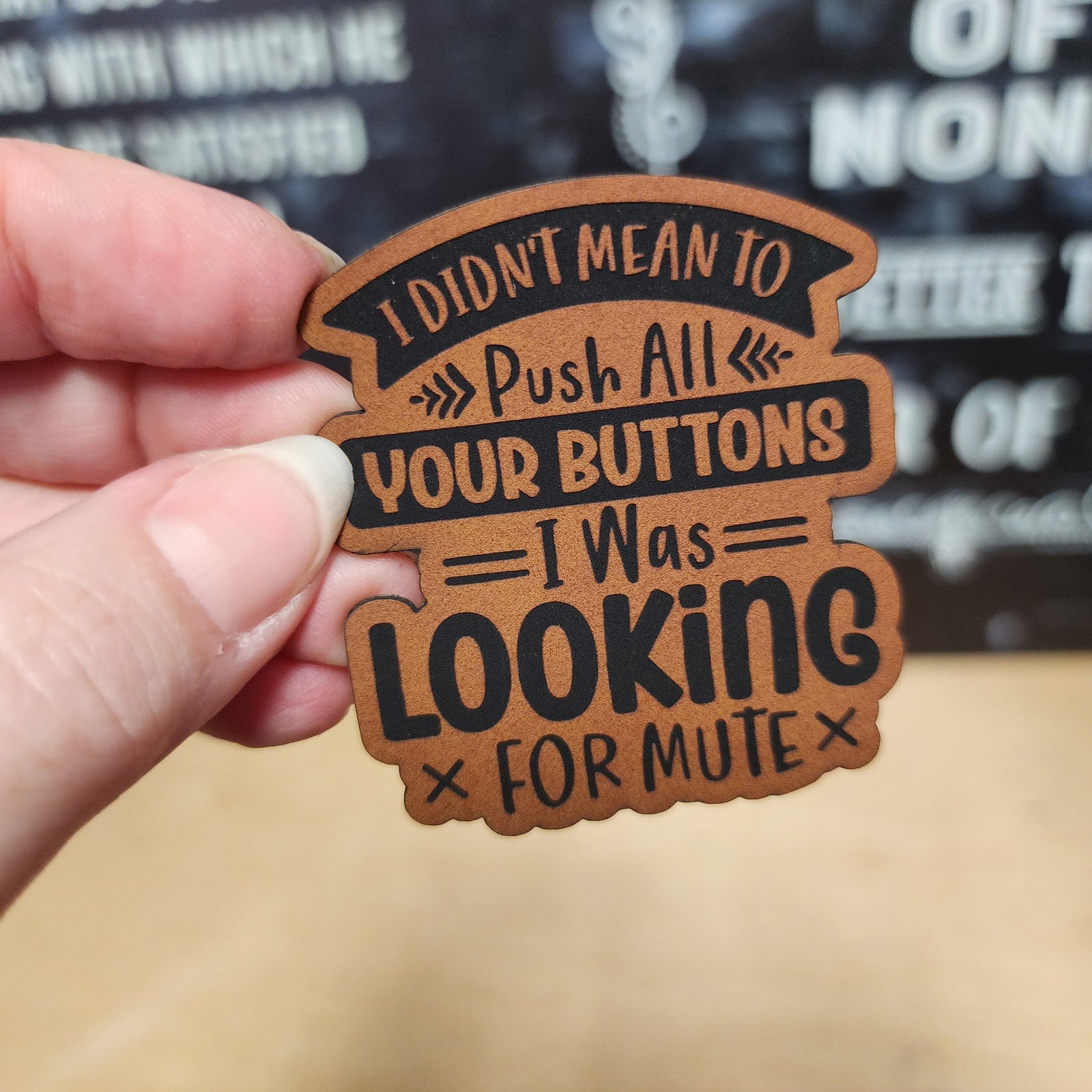 Humorous leatherette hat patch saying 'I Didn't Mean to Push All Your Buttons I Was Looking for Mute'.