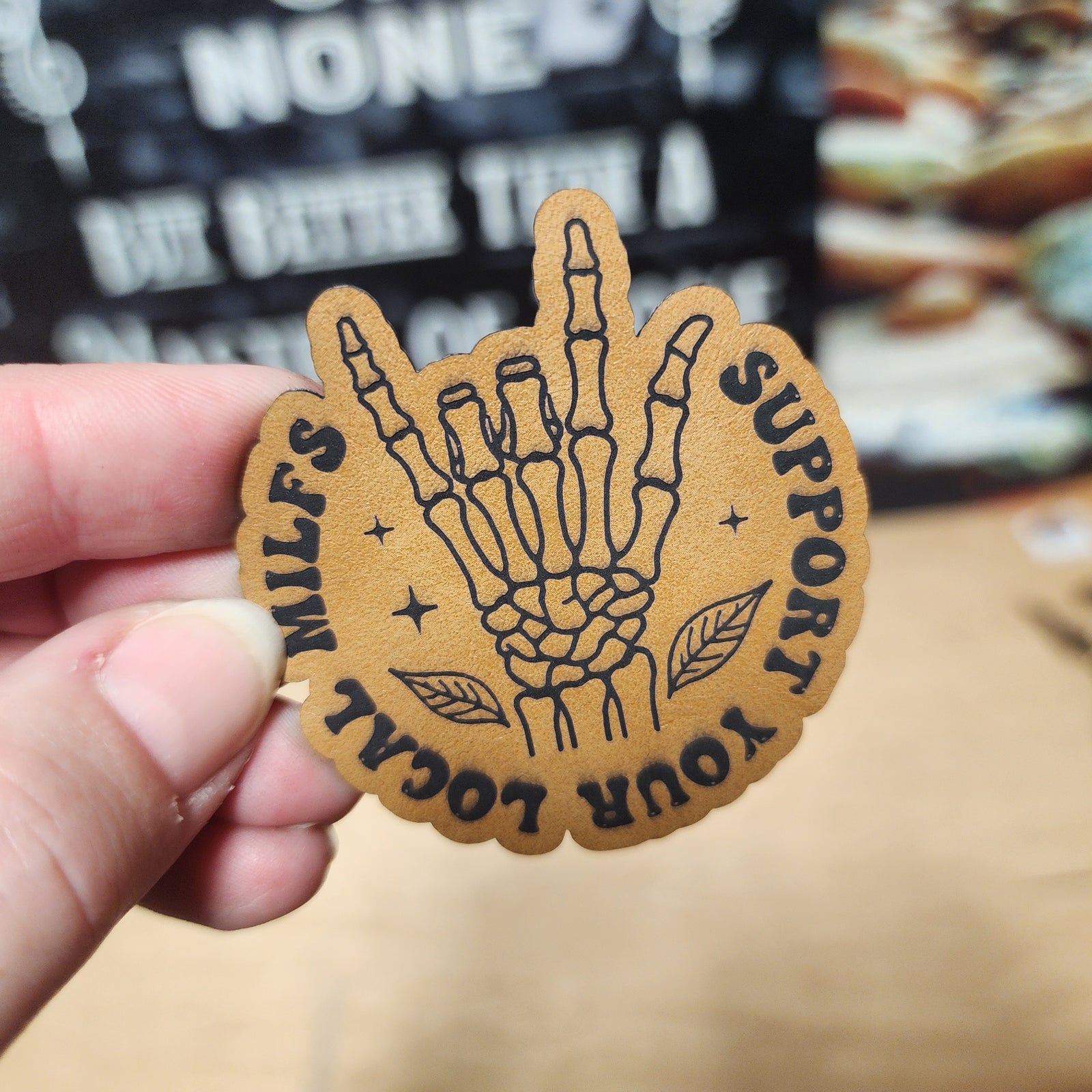 Support Your Locals leatherette hat patch featuring a skeleton hand design, perfect for unique accessories.