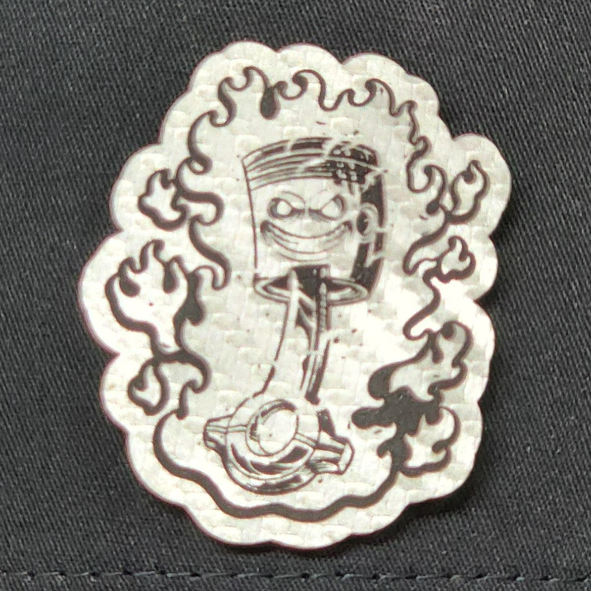 Unique leatherette hat patch featuring a cartoonish flame character, perfect for adding flair to your cap collection.