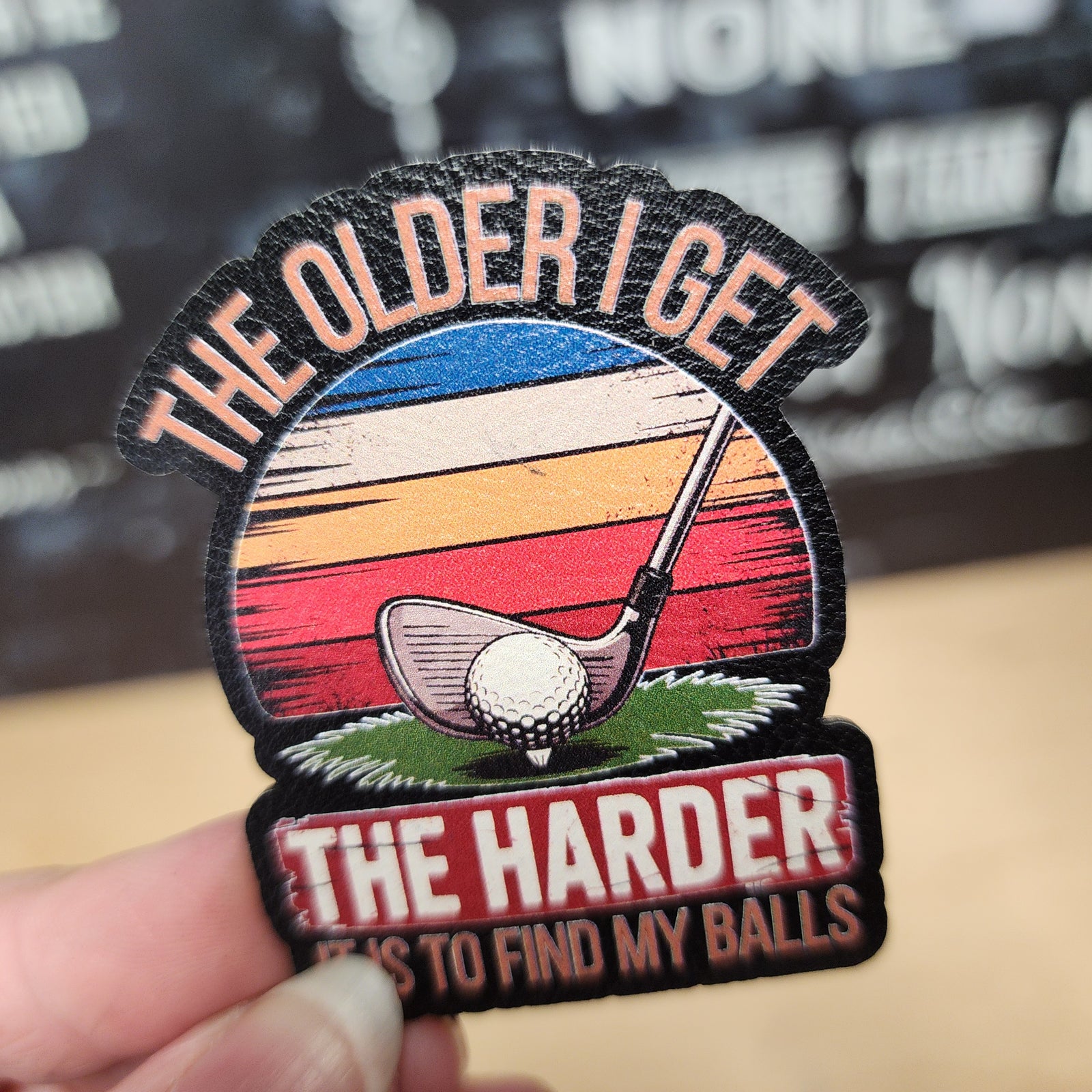 Golf humor leatherette hat patch, 'The Older I Get, The Harder It Is To Find My Balls' design for golf enthusiasts.
