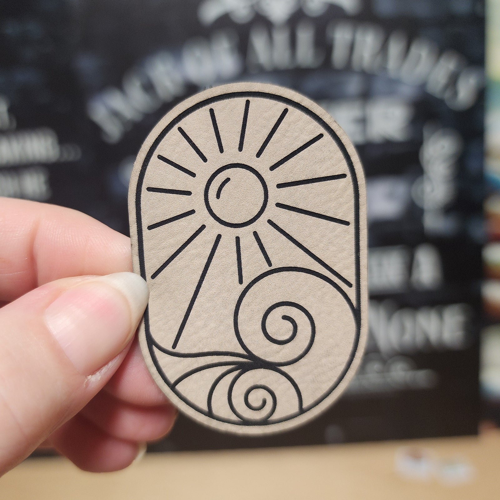 Sun and swirl leatherette hat patch, perfect for adding a unique touch to hats and accessories.