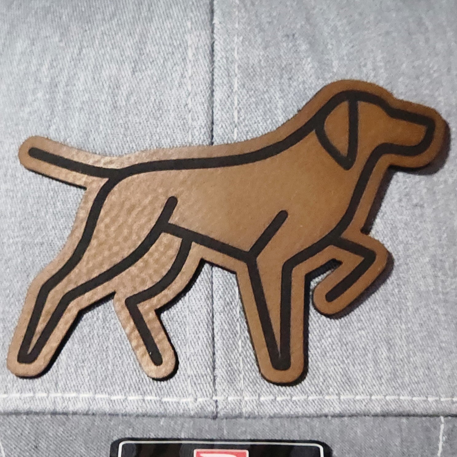Leatherette dog hat patch, perfect for pet lovers and outdoor enthusiasts, adds style to any cap.