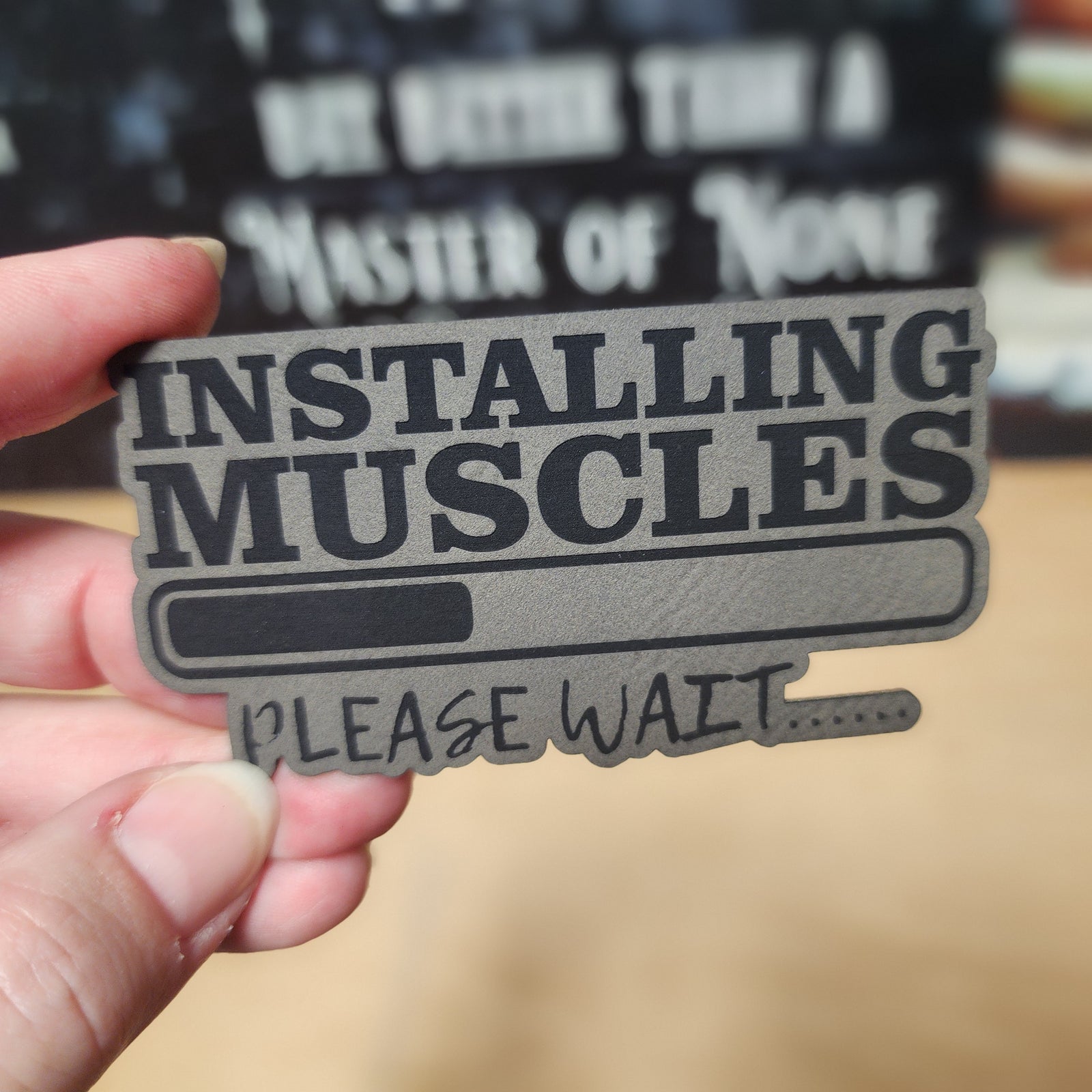 Funny leatherette hat patch 'Installing Muscles Please Wait' perfect for gym lovers and fitness enthusiasts.