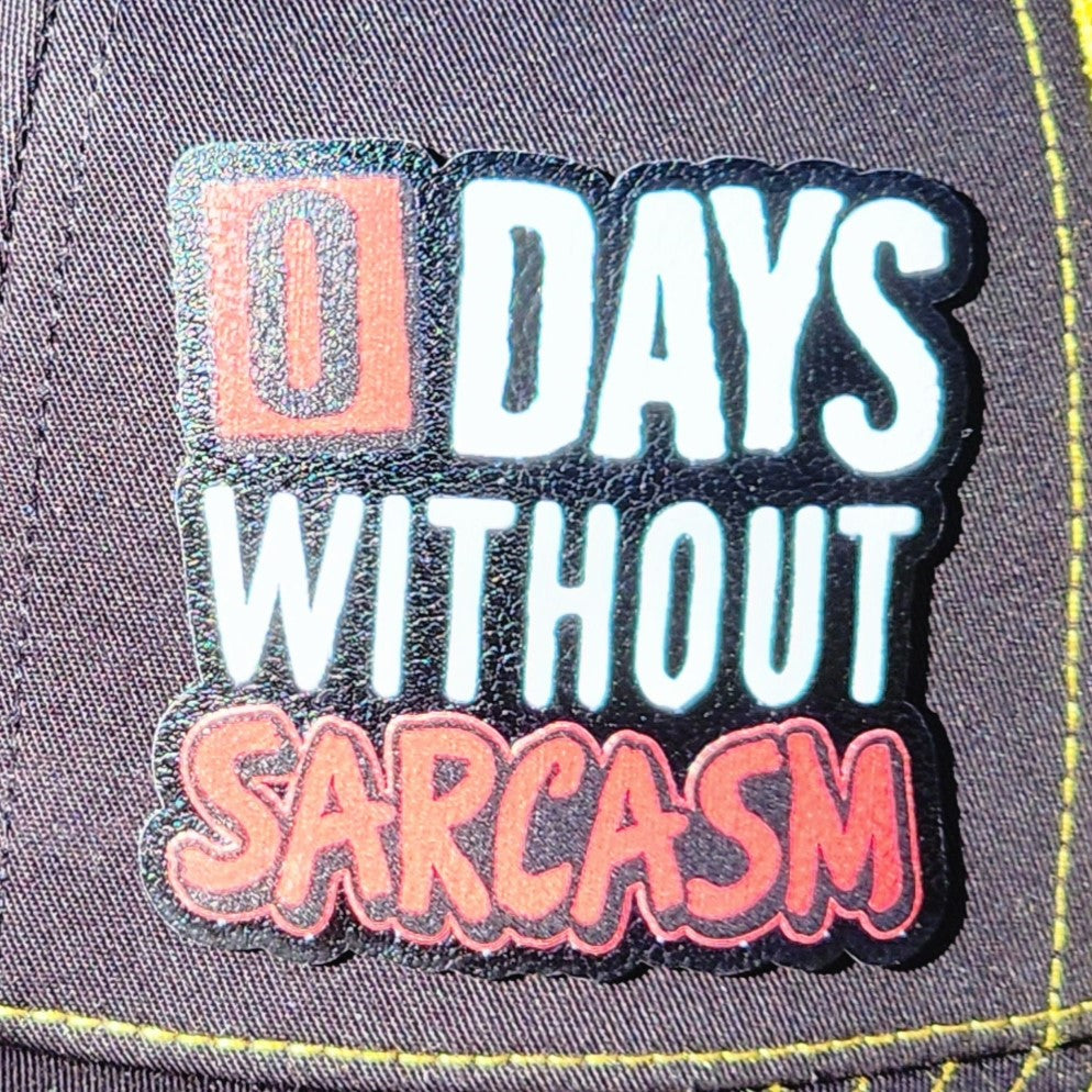Funny leatherette hat patch saying '0 Days Without Sarcasm' for casual hats and humorous gift ideas.
