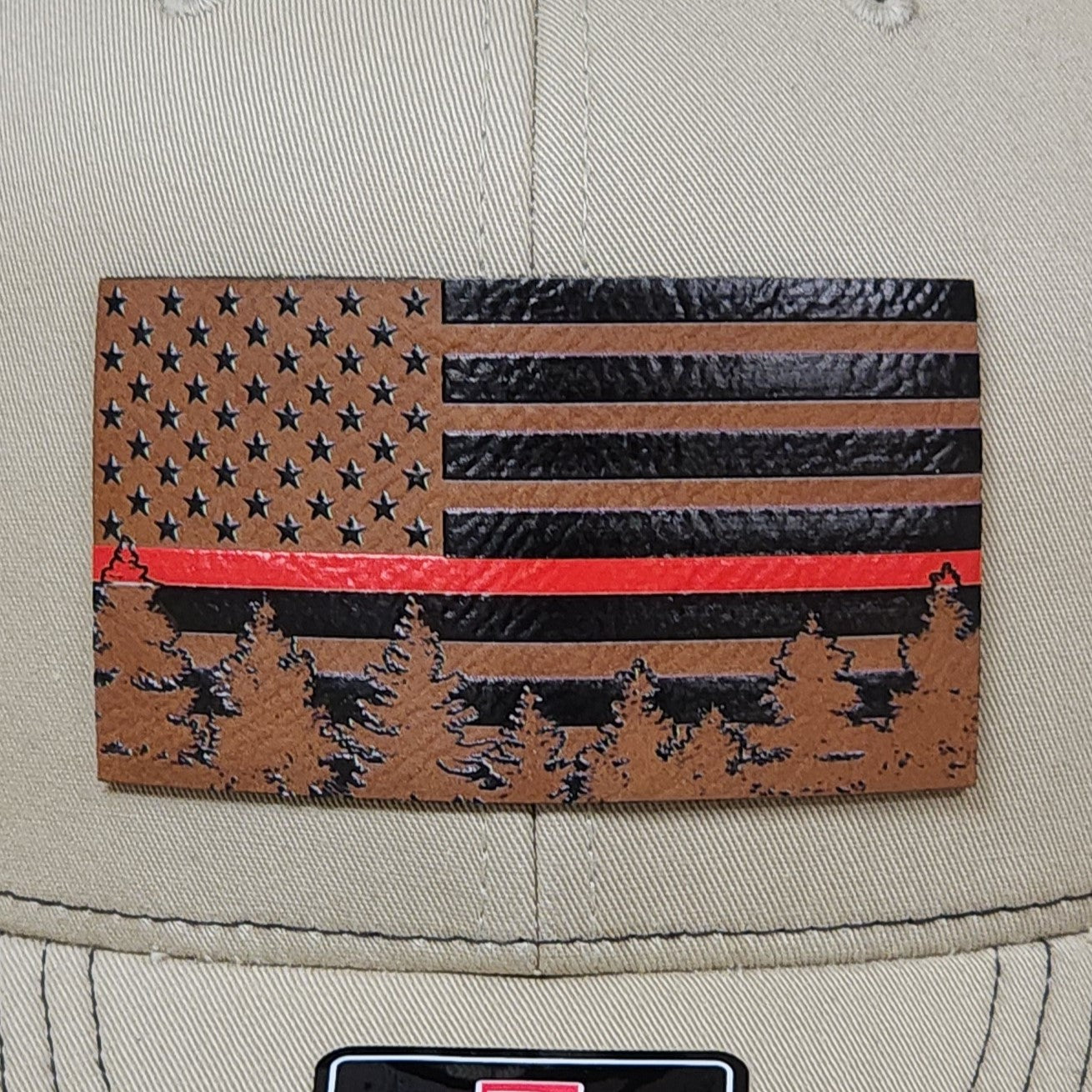 Leatherette hat patch featuring American flag design with red line and pine trees, perfect for patriotic outdoor enthusiasts.