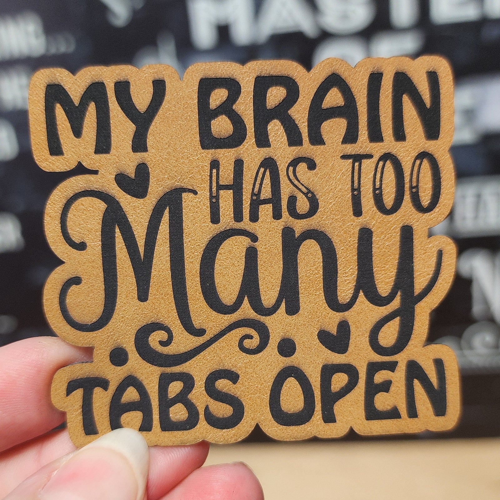 Humorous leatherette hat patch with 'My Brain Has Too Many Tabs Open' design for quirky gifts.