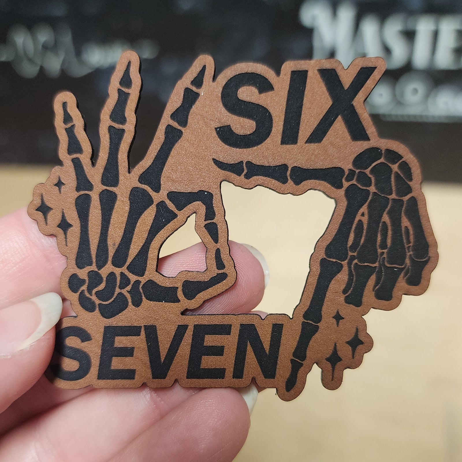 Skeleton hands leatherette hat patch featuring 'SIX SEVEN' for Halloween or spooky style outfits.