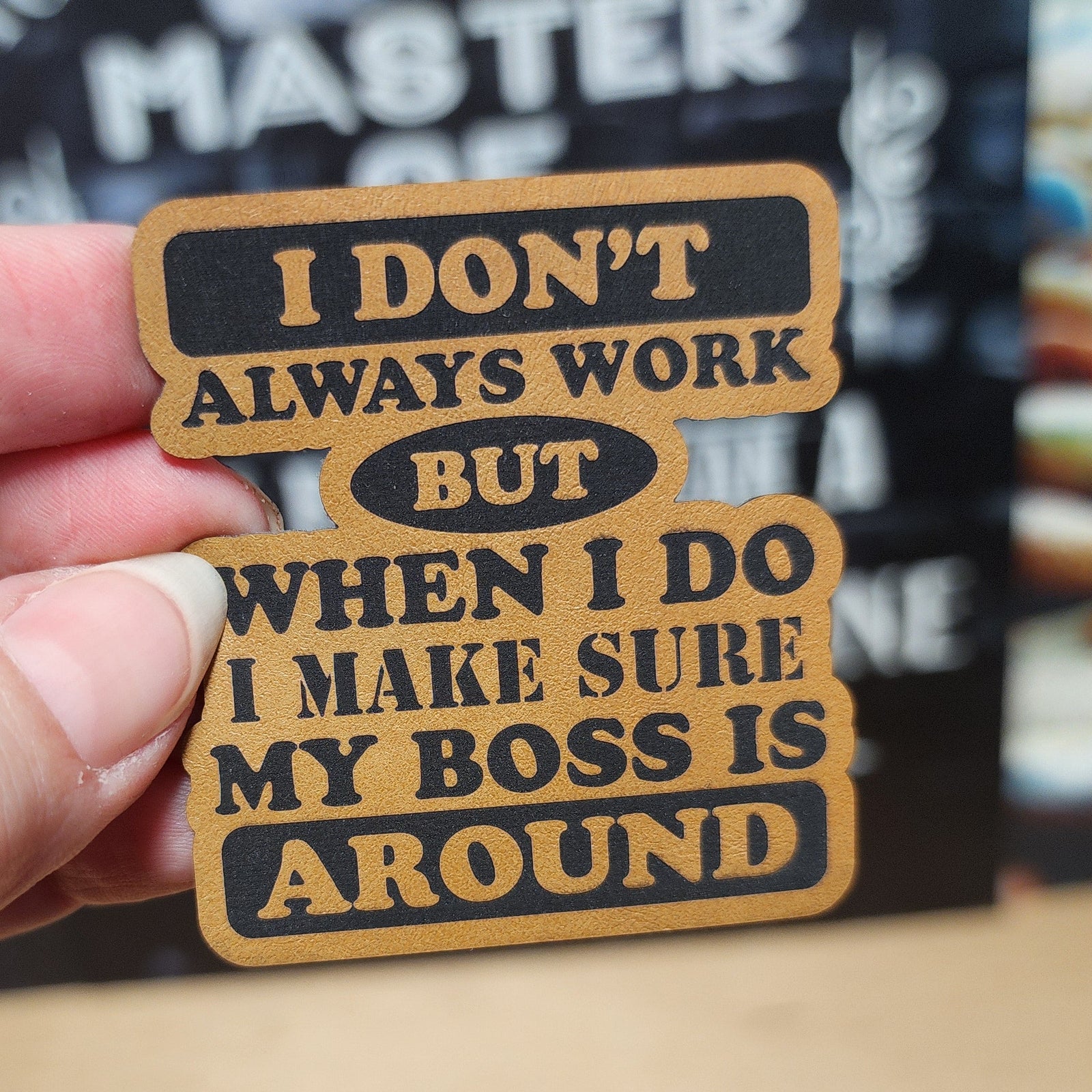 Funny leatherette hat patch saying 'I don’t always work but when I do, my boss is around' for humor-loving professionals.