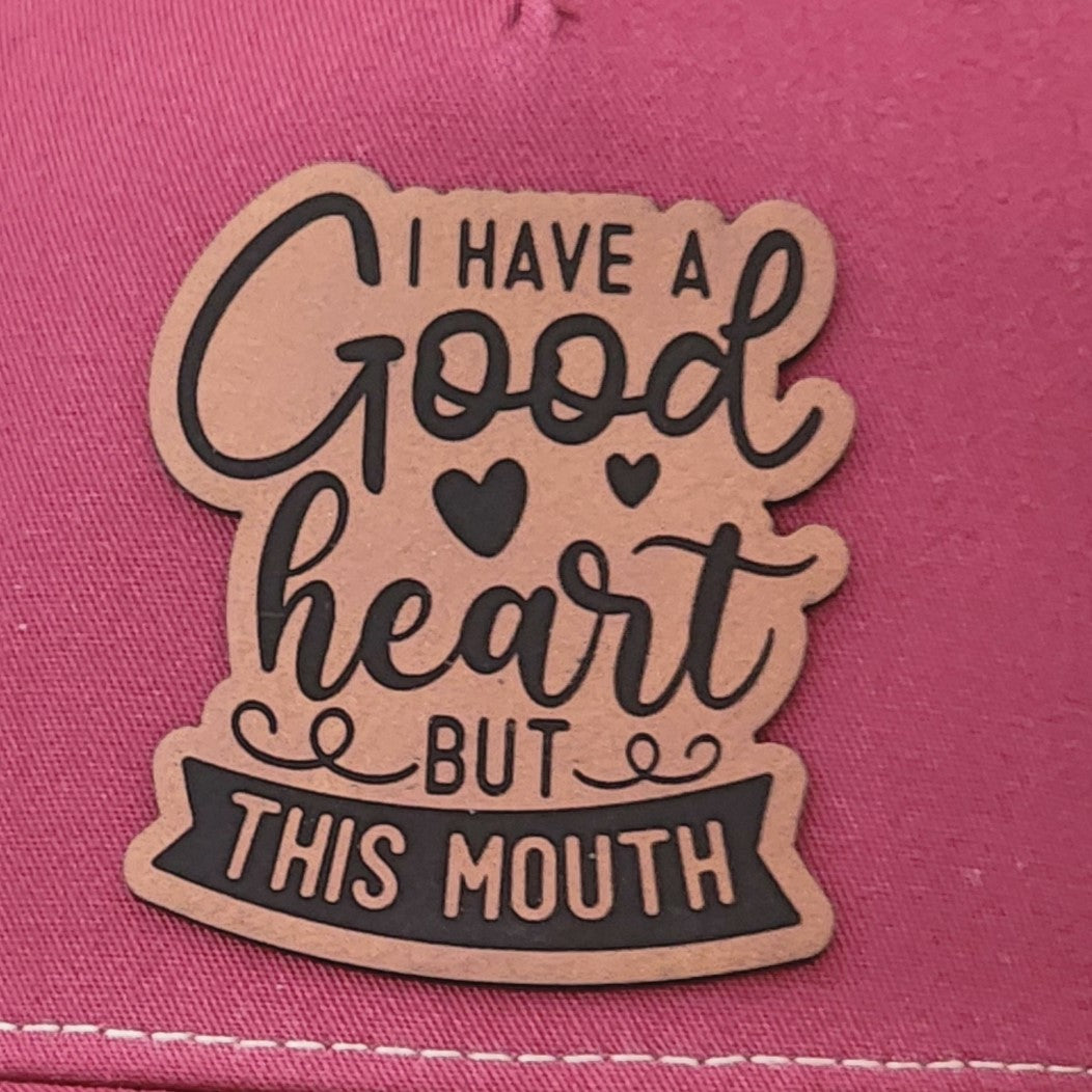 Leatherette hat patch with 'Good heart but this mouth' for humorous cap lovers and quirky fashion statements.