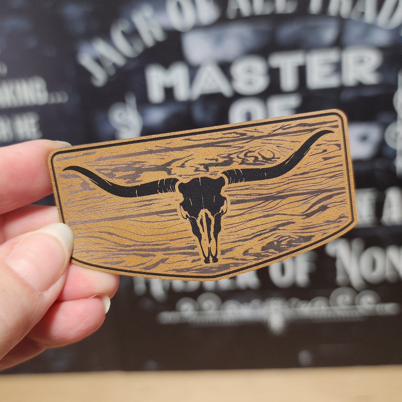 Leatherette hat patch featuring a rustic longhorn skull design, perfect for cowboy hats and western apparel.