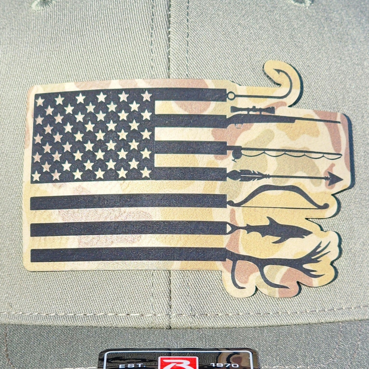 Patriotic camo leatherette hat patch featuring US flag and fishing gear, perfect for outdoor enthusiasts.