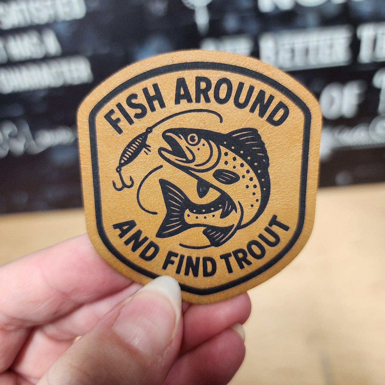 Fish Around and Find Trout leatherette hat patch for fishing enthusiasts and outdoor adventure lovers.
